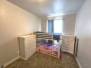 Carpeted bedroom with baseboards