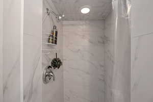 Full bathroom featuring tiled shower
