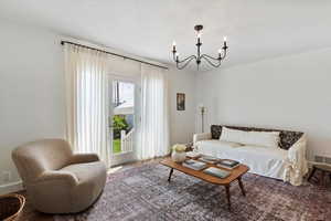 Living room with a chandelier french doors