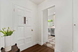 Foyer entrance with baseboards and wood finished floors