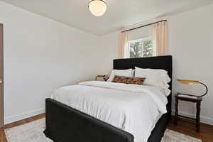 Bedroom featuring baseboards and wood finished floors