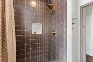 Full bathroom featuring a tile shower