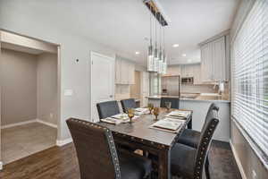 Dining room featuring dark wood-style floors, recessed lighting, and baseboards
