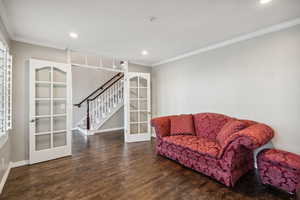 Sitting room featuring french doors, crown molding, wood finished floors, baseboards, and recessed lighting