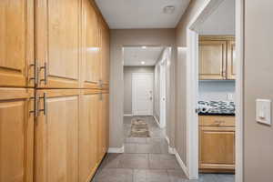 Hallway featuring baseboards and recessed lighting