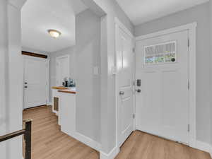 Foyer featuring light wood-type flooring and baseboards