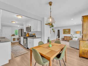 Dining room featuring light wood-style flooring and recessed lighting