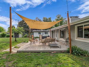 Wooden deck featuring an outdoor living space and an outbuilding