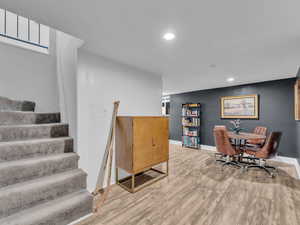 Home office with light wood-type flooring, baseboards, and recessed lighting