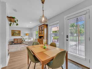 Dining space with light wood finished floors, recessed lighting, and baseboards