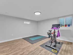 Workout room with wood finished floors and baseboards