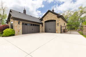 Garage with fence, a gate, and concrete driveway
