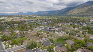 Aerial view of property's location featuring a mountainous background and nearby suburban area