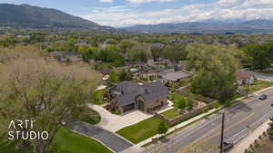 Aerial overview of property's location featuring a mountainous background and nearby suburban area