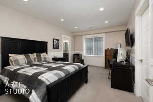 Bedroom with wainscoting, light colored carpet, recessed lighting, and a desk