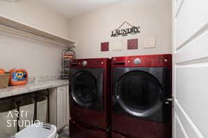 Laundry room with washer and clothes dryer