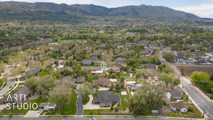 Aerial overview of property's location featuring a mountain backdrop and nearby suburban area