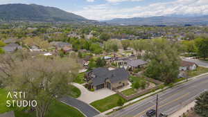 Aerial view of property's location with a mountain backdrop and nearby suburban area