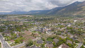 Aerial view of property's location with mountains and nearby suburban area