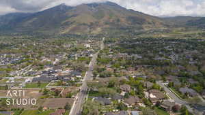 Aerial view of property's location featuring a mountain backdrop and nearby suburban area