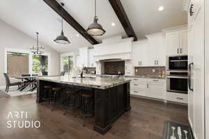 Kitchen with oven, tasteful backsplash, a sink, white cabinetry, and recessed lighting