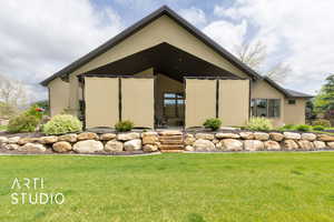 View of home's exterior with a lawn and stucco siding