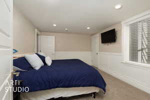 Carpeted bedroom featuring wainscoting and recessed lighting