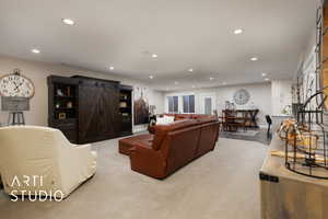 Living room featuring recessed lighting, a barn door, and baseboards