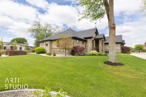 View of front of home with stone siding, stucco siding, and roof with shingles