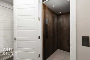 Hallway with elevator and recessed lighting