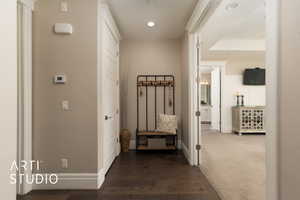 Hall featuring baseboards, recessed lighting, and dark wood finished floors