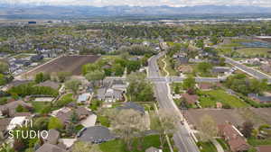 Aerial view of property's location featuring a mountain backdrop and nearby suburban area