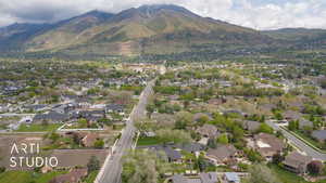 Aerial view of property's location featuring a mountainous background and nearby suburban area