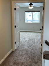 Spare room featuring carpet floors, ceiling fan, baseboards, and a textured ceiling