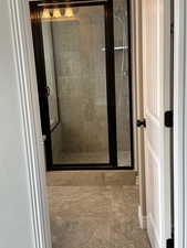 Full bathroom featuring a stall shower