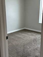 Empty room featuring carpet floors and baseboards