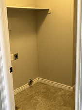 Washroom with electric dryer hookup and baseboards