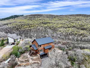 View from above of property featuring a heavily wooded area