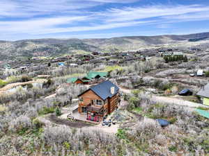 View from above of property with a mountain backdrop