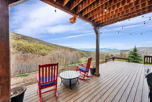 Wooden terrace featuring a mountain view