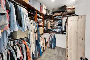 Walk in closet featuring carpet