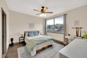 Bedroom with wood finished floors, baseboards, and a ceiling fan