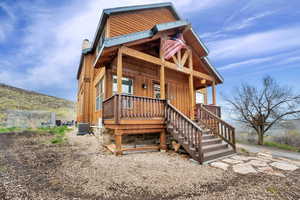 Exterior space featuring central AC, covered porch, stairway, and a chimney