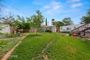 View of yard with a playground and stairs