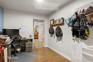 Home office featuring wood finished floors and baseboards