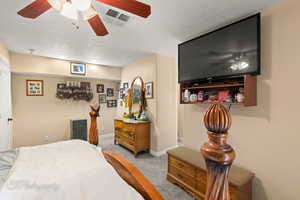 Bedroom featuring carpet flooring, baseboards, and a ceiling fan