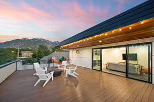 Wooden terrace with a mountain view and a fire pit