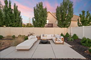 View of patio with an outdoor living space with a fire pit and a fenced backyard