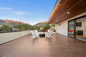 Wooden terrace featuring a mountain view and a sink