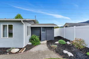 Property entrance with fence and stucco siding
